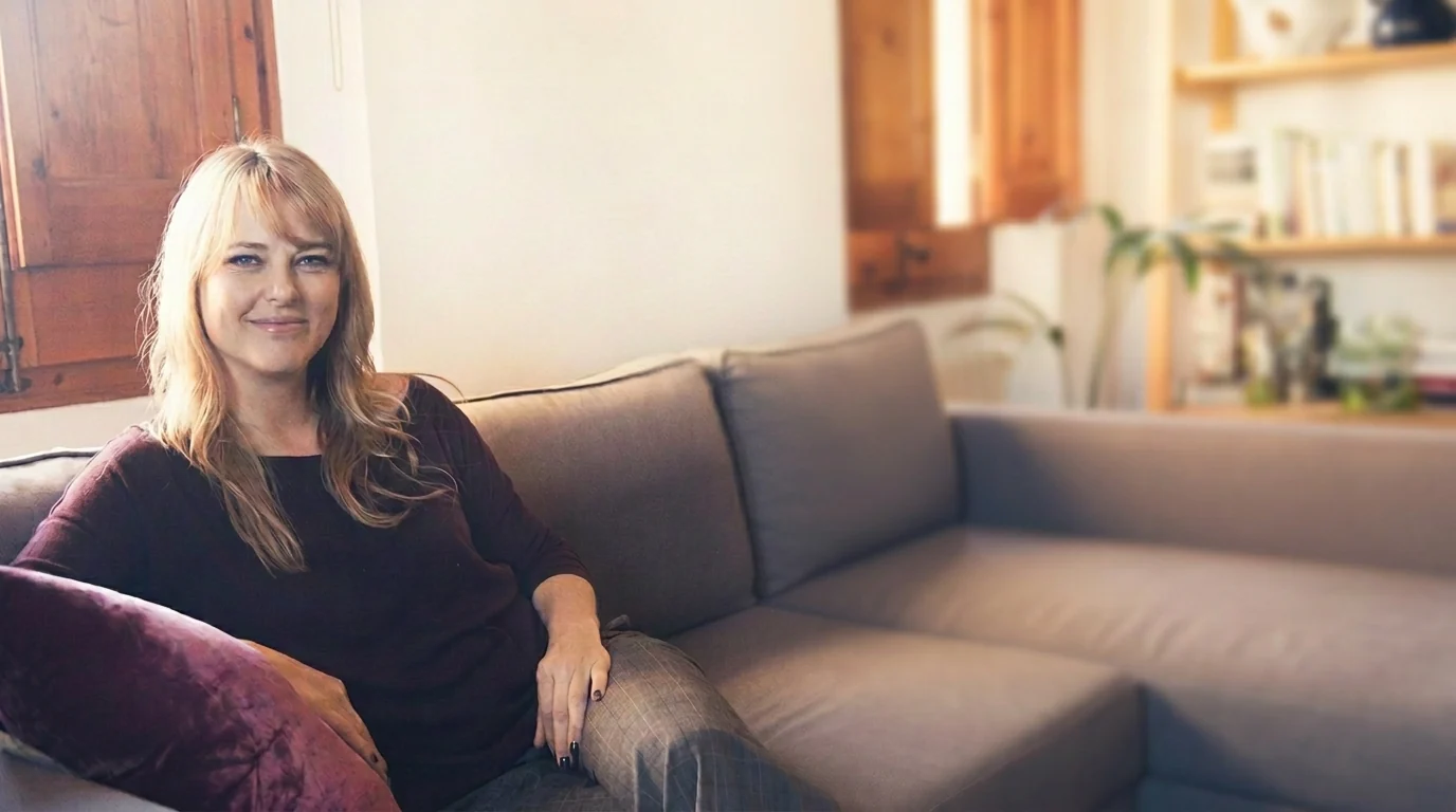 Dr Jena Field, counselling psychologist, seated in her consulting space